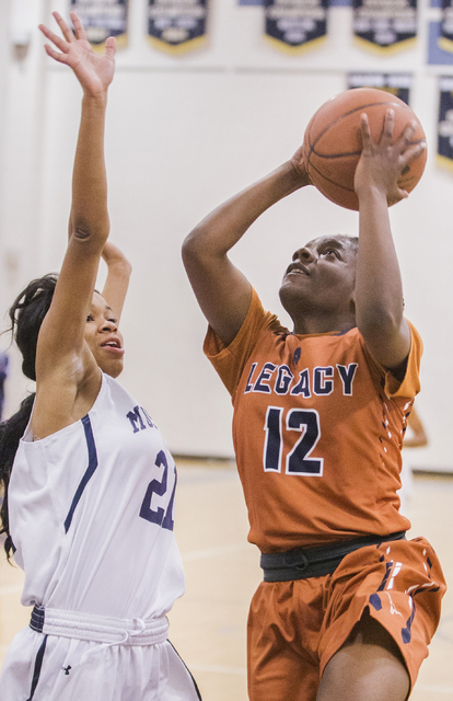 Legacy’s Damijah Yarbrough (12) drives past Shadow Ridge’s Mi’Theajah Alex ...