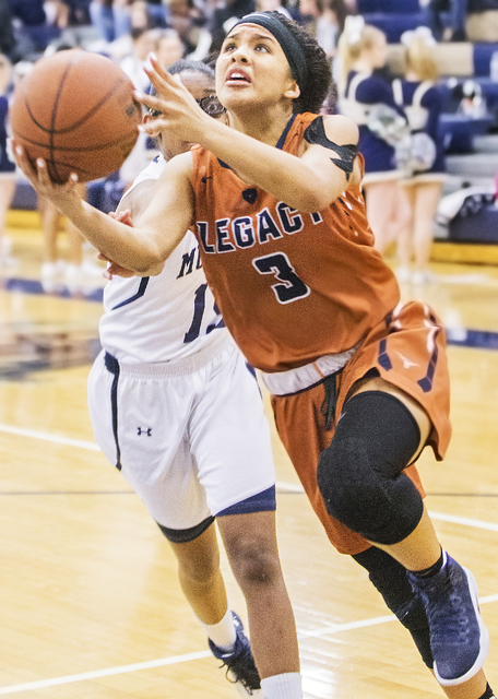 Legacy’s Taeha Pankey (3) slices to the rim past Shadow Ridge’s Amaia McCoy (15) ...