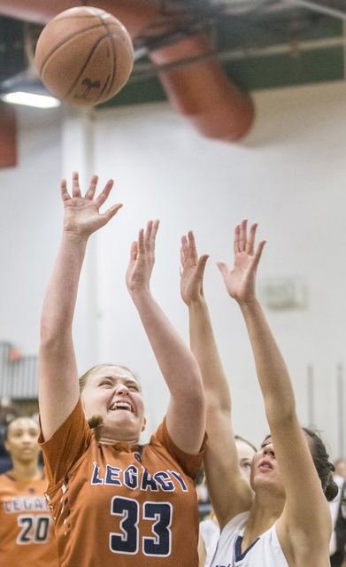 Legacy’s Samantha Greene (33) drives to the basket past Shadow Ridge’s Alexa Ma ...