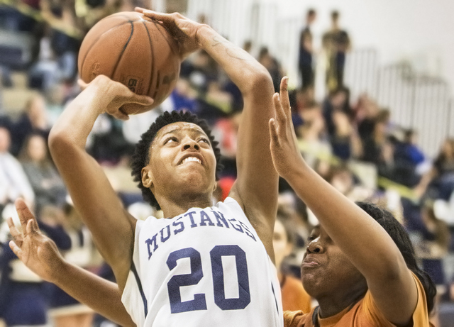 Shadow Ridge’s Summer Plunkett (20) drives past Legacy’s Zania Watkins (42) duri ...