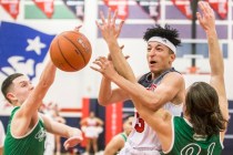 Liberty’s Tyrone Marigney (3) gets tied up with Green Valley’s Canyon Lewis (21) ...