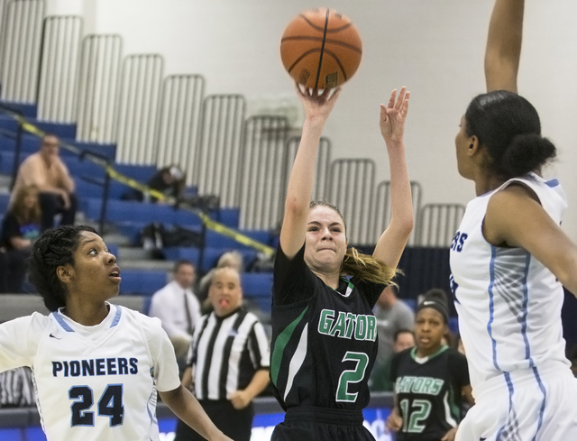 Green Valley’s Temerity Bauer (2) shoots a jump shot over Canyon Springs’ Dayonn ...