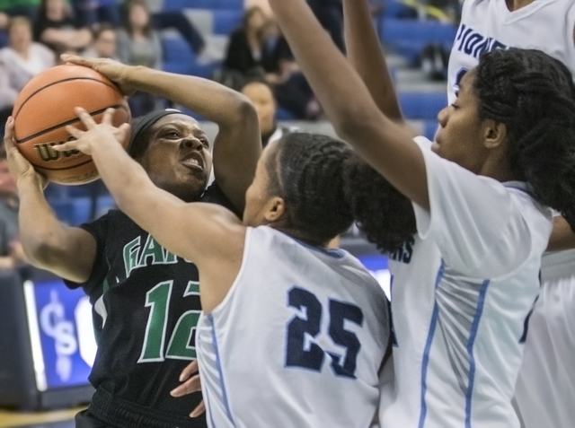 Green Valley’s Jamaica Lewis (12) gets tied up with Canyon Springs’ D’Licy ...