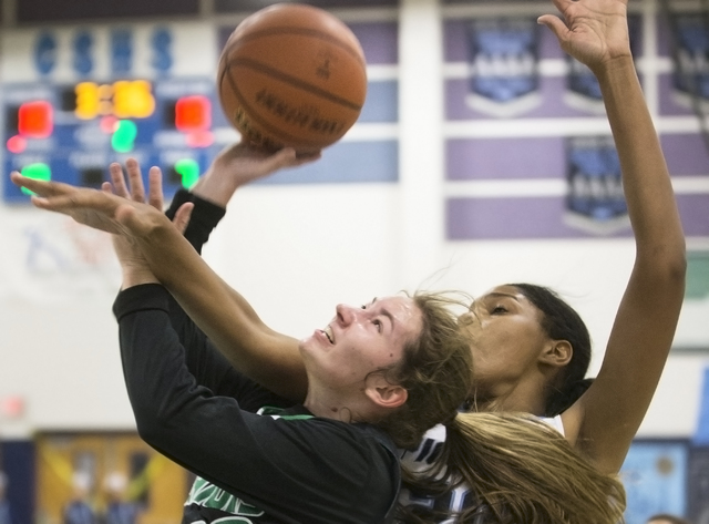 Green Valley’s Brooke Haney (20) drives past Canyon Springs Yemiyah Morris (20) durin ...