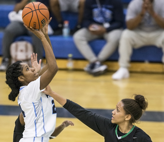 Canyon Springs’ Dayonna Maddox (24) shoots a jump shot over Green Valley’s Samar ...