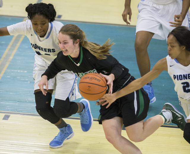 Green Valley’s Brooke Haney (20) pushes the ball up court past Canyon Springs’ D ...