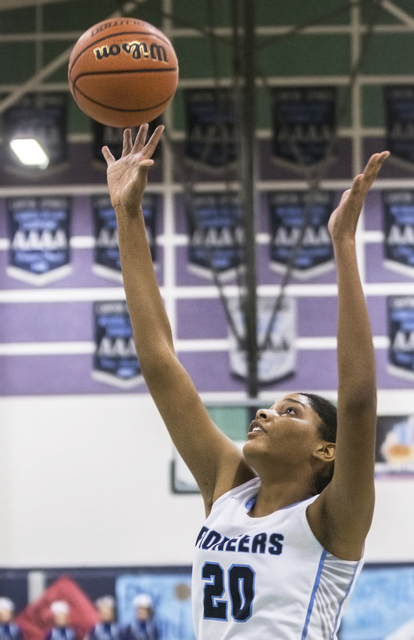 Canyon Springs’ Yemiyah Morris (20) drives baseline past Green Valley’s Brooke H ...