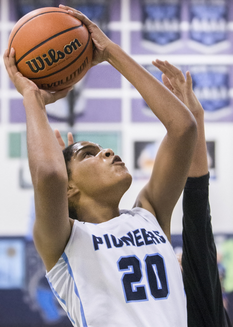 Canyon Springs’ Yemiyah Morris (20) shoots a jump shot with a hand in her face during ...