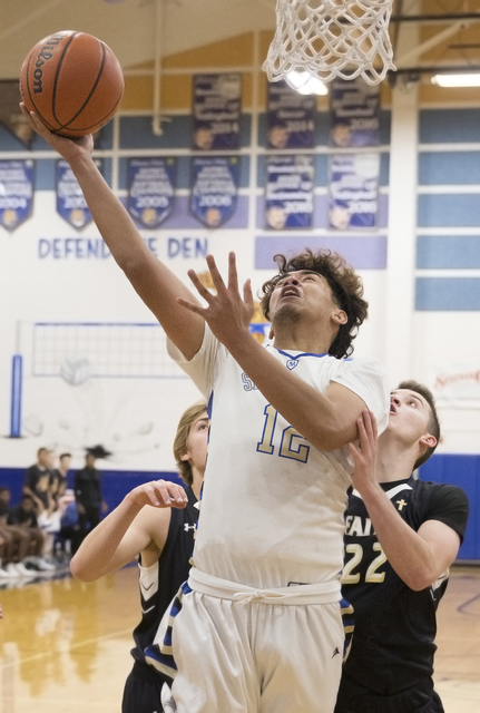 Sierra Vista’s Maui Sera Josef (12 ) drives past Faith Lutheran’s Connor Nichols ...