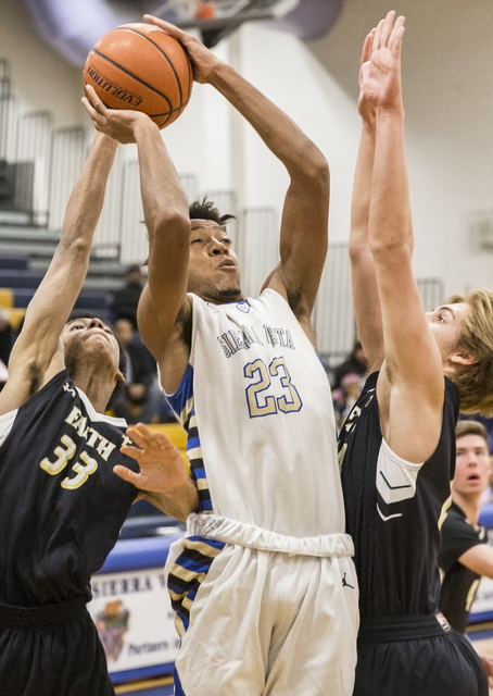 Sierra Vista’s Chris McCoy (23) shoots over Faith Lutheran’s Drew Kessler (33) o ...