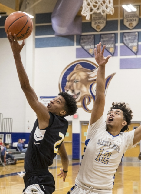 Faith Lutheran’s Jaylen Fox (2) drives past Sierra Vista’s Maui Sera Josef (12) ...