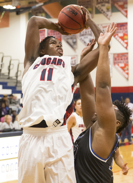 Coronado’s Will Weems (11) shoots over Desert Pines’ Jalen Graves (12) on Monday ...