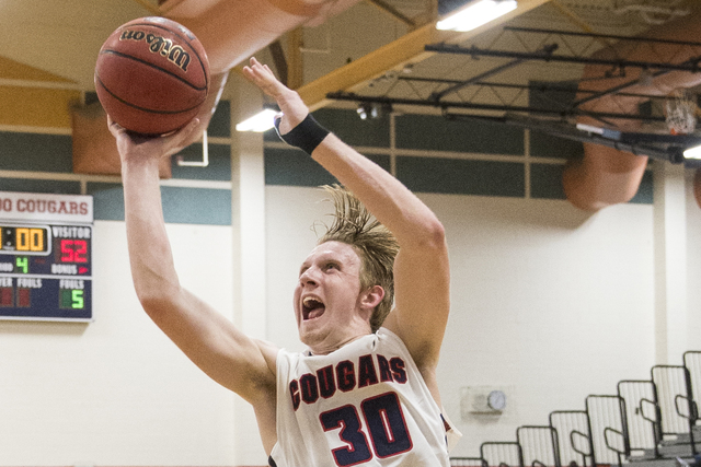 Coronado’s Kennedy Koehler (30) drives past Desert Pines’ Jalen Graves (12) on M ...