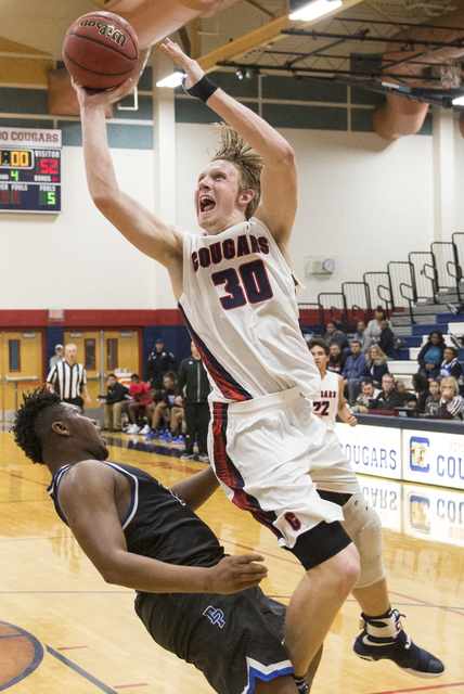 Coronado’s Kennedy Koehler (30) drives past Desert Pines’ Jalen Graves (12) on M ...