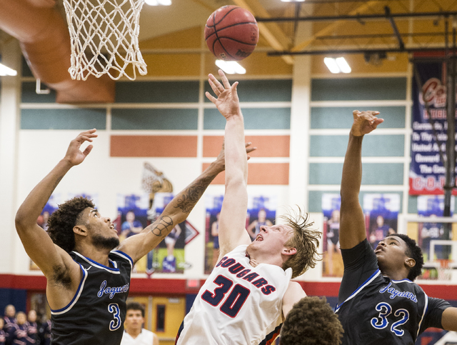 Coronado’s Kennedy Koehler (30) fights for a rebound with Desert Pines’ Trevon A ...