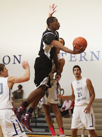 Findlay Prep forward Horace Spencer (0) drives past Team Pennsylvania’s Miko Jenkins ( ...