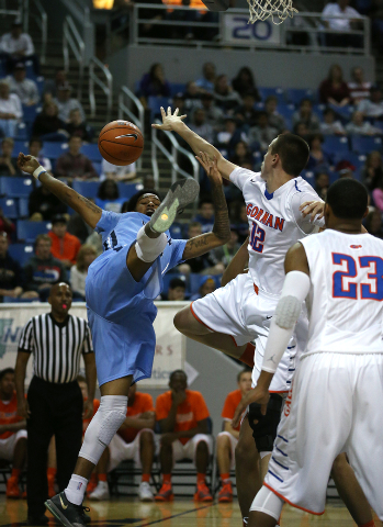 Bishop Gorman’s Zach Collins blocks the shot of Canyon Springs’ Shaqille Carr du ...