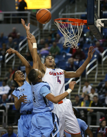 Bishop Gorman’s Chase Jeter shoots over Canyon Springs defenders Darrell McCall and Jo ...