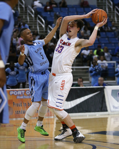 Canyon Springs’ Gerad Davis and Bishop Gorman’s Stephen Zimmerman compete during ...