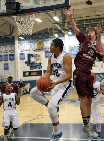 Centennial’s Eddie Davis (50) goes up for a shot past Cimarron-Memorial forward Kyle S ...