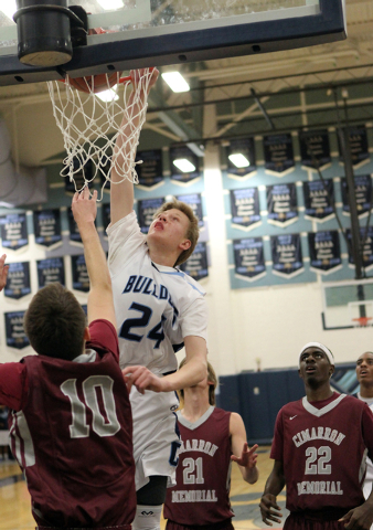 Centennial forward Garett Scheer (24) goes up for a shot over Cimarron-Memorial guard Austin ...