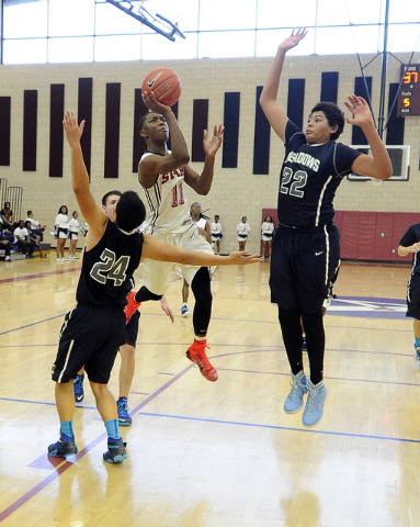 Agassi Prep guard Deishuan Booker (11) is fouled by The Meadows forward Michael Jin (24) whi ...