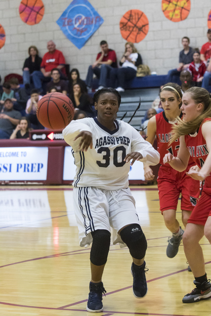 Agassi Prep guard Sharmayne Finley (30) passes the ball during a game against Lincoln County ...