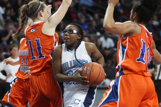 Centennial guard Tanjanae Wells drives to the basket between Bishop Gorman guard Madison Ulr ...