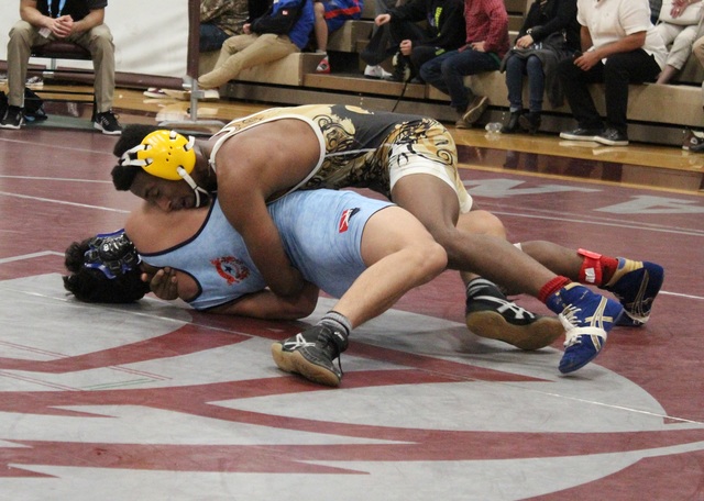 Clark 120-pounder Melekte Demdemyanos works on top of Centennial’s Sammy Salazar, as h ...