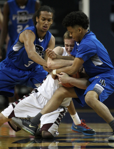 Elko’s Cody Nielsen wrestles for a loose ball with Desert Pines’ Kevin Butler, l ...