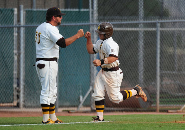 Jay DeSoto (right) gets a fist bump from head coach Mike O’Rourke after hitting a home ...