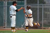 Jay DeSoto (right) gets a fist bump from head coach Mike O’Rourke after hitting a home ...