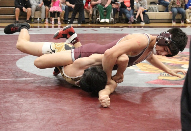 Cimarron-Memorial 126-pounder Daniel Rodriguez works on top of Clark’s Raymond Gonzale ...