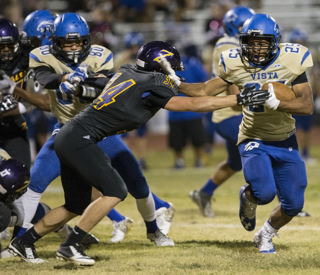 Sierra Vista running back Isaiah Zavala (25) stiff arms Durango defender Jacob Bourgault ( ...