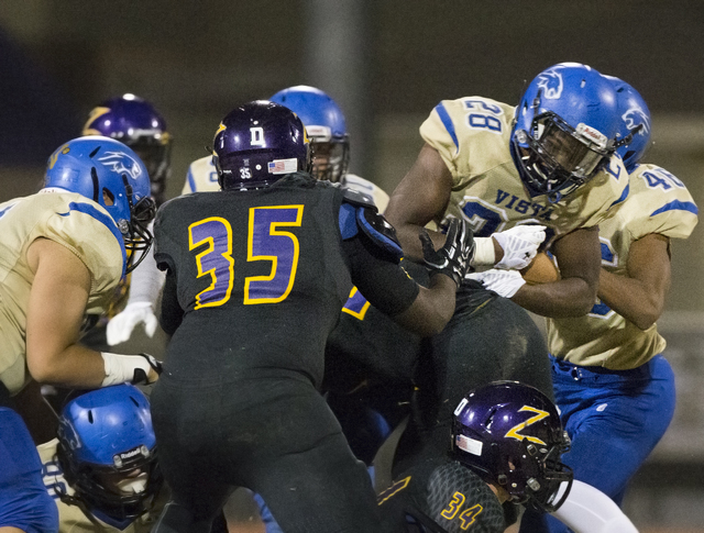 Sierra Vista running back Bryan Lagrange (28) dives into Durango defenders on Friday, Oct. 2 ...