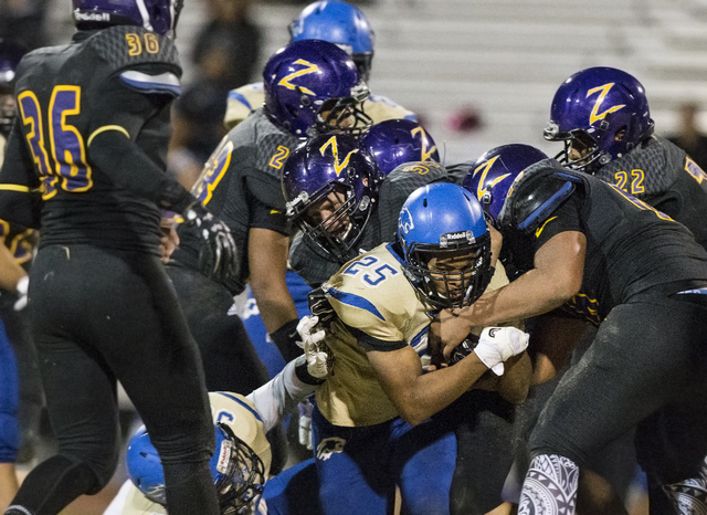 Sierra Vista running back Isaiah Zavala (25) gets stacked up by Durango defenders on Friday, ...