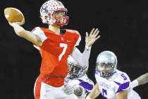 Liberty’s Kenyon Oblad (7) makes a pass with Silverado defenders on his back during th ...