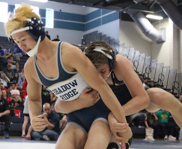 Centennial freshman Nico Antuna works from behind against Shadow Ridge senior A.J. Thai-Baut ...