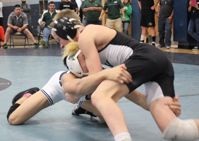 Virgin Valley freshman Ty Smith (right) stuffs a shot by Shadow Ridge’s A.J. Thai-Baut ...