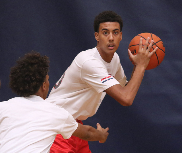 Greg Floyd, Jr., right, has possession of the ball and is guarded by Capri Uzan during a Las ...