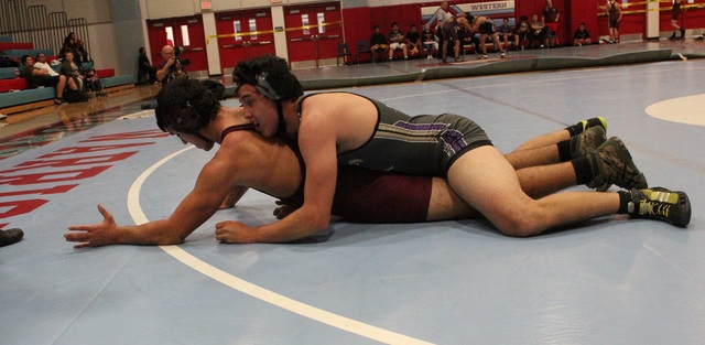 Sunrise Mountain junior Alex Herrera works on top of Pahrump Valley’s Garrett Monje du ...