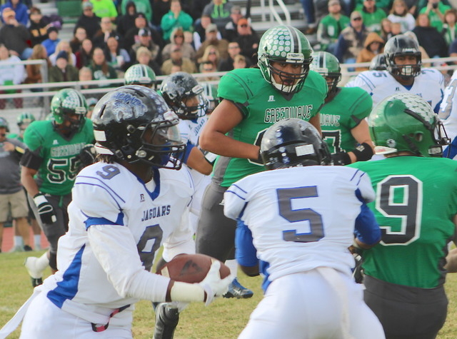 Desert Pines’ Andre Watts (9) relies on a block from Dillard Davis against Churchill i ...