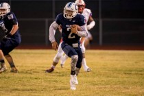 Centennial Bulldogs quarterback Jamaal Evans (2) runs with the ball against the Liberty Patr ...