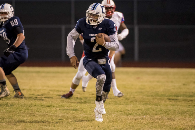 Centennial Bulldogs quarterback Jamaal Evans (2) runs with the ball against the Liberty Patr ...