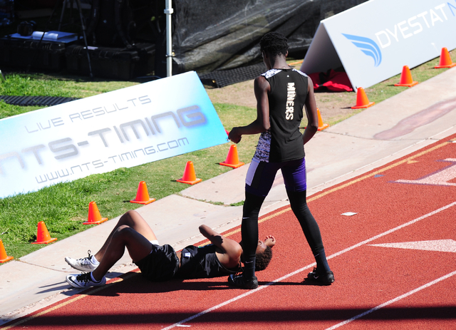 Sunrise Mountain runner Steven Walker, right, stops his race to help out Palo Verde runner C ...