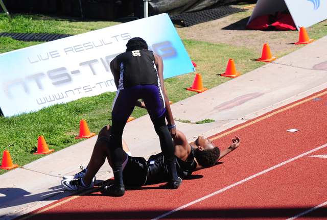 Sunrise Mountain runner Steven Walker, right, stops his race to help out Palo Verde runner C ...