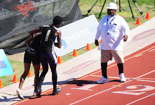 Sunrise Mountain runner Steven Walker, right, stops his race to help out Palo Verde runner C ...