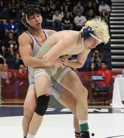 Cimarron-Memorial’s Angel Laurente prepares to throw Shadow Ridge’s Jonah McKee ...