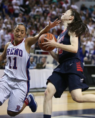 Reno’s Daranda Hickey fouls Liberty’s Kealy Brown during the Division I champion ...