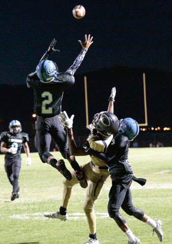 Canyon Springs junior Diamante Burton (2) leaps for the ball as Canyon Springs junior Tyshon ...